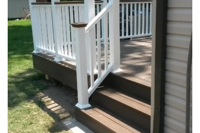 Example of an arts and crafts backyard deck design in Newark