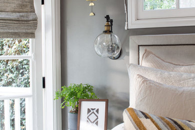 Example of a mid-sized trendy master light wood floor bedroom design in Los Angeles with gray walls