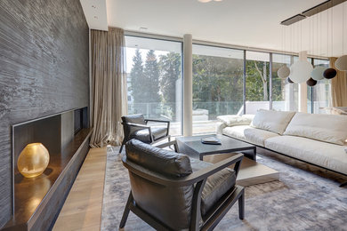 Inspiration for a large contemporary open concept light wood floor and beige floor family room remodel in Munich with a two-sided fireplace and a wood fireplace surround