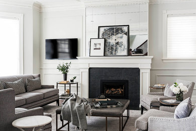 Photo of a mid-sized transitional living room in Montreal with white walls, dark hardwood floors and a standard fireplace.