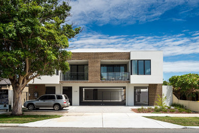 This is an example of a small contemporary two-storey brick white exterior in Perth with a hip roof.
