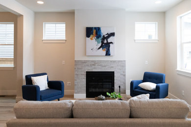 Small minimalist open concept light wood floor and beige floor living room photo in Portland with white walls, a standard fireplace, a brick fireplace and no tv
