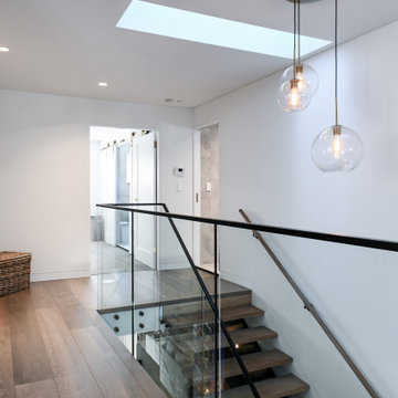 Expansive hallway with floating stairs