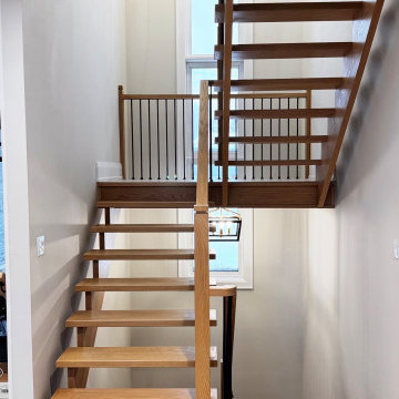 Modern White Oak Open Riser Staircase with Black Metal Balusters