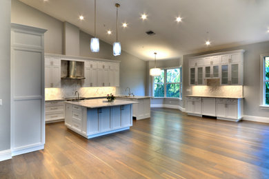 Inspiration for an expansive transitional kitchen in Miami with dark hardwood floors and vaulted.
