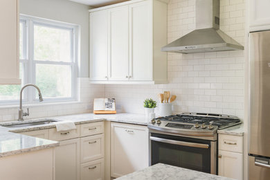 Example of a mid-sized minimalist galley eat-in kitchen design in St Louis with a single-bowl sink, beaded inset cabinets, white cabinets, marble countertops, white backsplash, subway tile backsplash, stainless steel appliances and an island