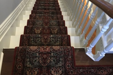 Staircase - mid-sized traditional painted u-shaped staircase idea in Toronto with painted risers
