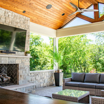 Pool-Side Outdoor Room with a Fireplace and Sitting Walls