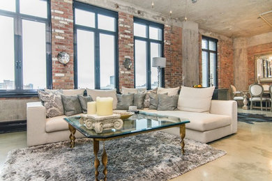 Example of a mid-sized eclectic open concept concrete floor living room design in Montreal with no fireplace and a media wall