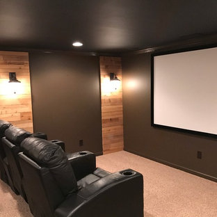 Example of a large urban enclosed carpeted home theater design in Atlanta with black walls and a projector screen