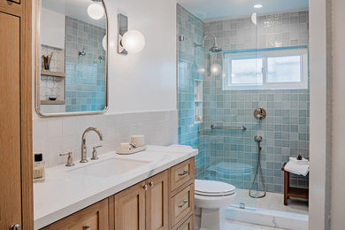 Bathroom - small coastal master white tile and ceramic tile ceramic tile, white floor and single-sink bathroom idea in Los Angeles with shaker cabinets, light wood cabinets, a two-piece toilet, white walls, an undermount sink, solid surface countertops, white countertops, a niche and a built-in vanity