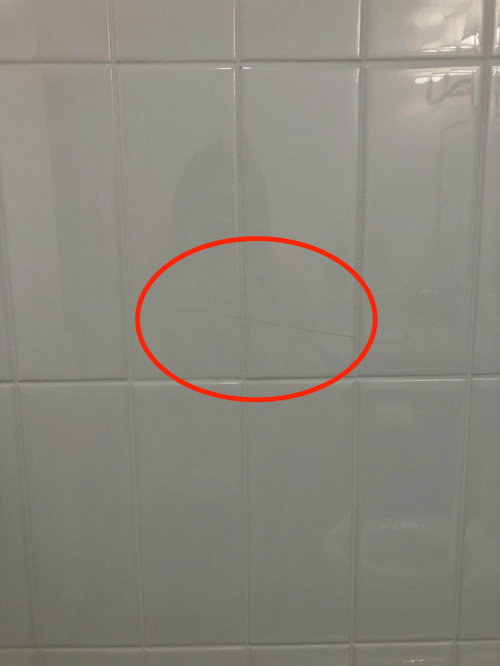 Tiles on the bathroom wall keep cracking