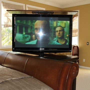 Hidden TV in furniture at the foot of the bed with TV lift cabinet