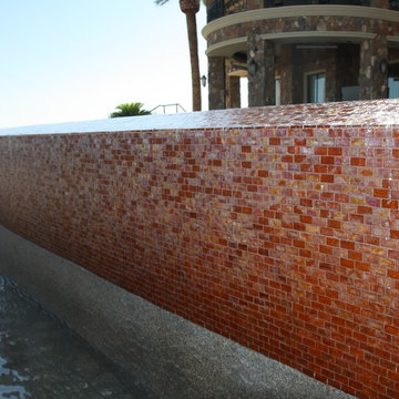 Glass tile projects- 1” X 2” iridescent red glass tile cover the 65 foot infinit