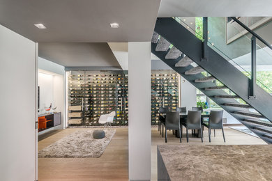 Example of a mid-sized trendy light wood floor wine cellar design in Toronto