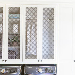 Photo of a country galley utility room in Calgary with a submerged sink, white cabinets, engineered stone countertops, green walls, ceramic flooring and a side by side washer and dryer.