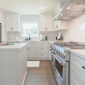 Symmetrical Newport Beach Kitchen with Black Accents and Globe Pendants