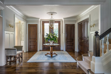 Entryway - traditional dark wood floor entryway idea in Boston with gray walls and a glass front door
