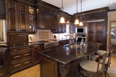 Inspiration for a large timeless ceramic tile and beige floor eat-in kitchen remodel in Other with an undermount sink, raised-panel cabinets, dark wood cabinets, granite countertops, beige backsplash, ceramic backsplash, stainless steel appliances and an island
