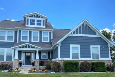 Inspiration for a large modern blue two-story wood and board and batten house exterior remodel in Indianapolis