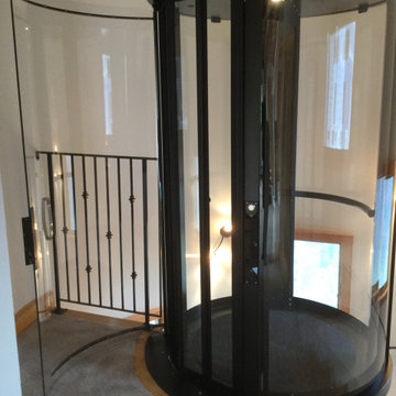 Round Acrylic Home Elevator Incorporated into Staircase