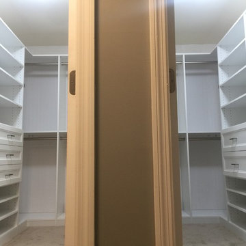 His and Hers Walk-in Closets with wainscott backing and other closets