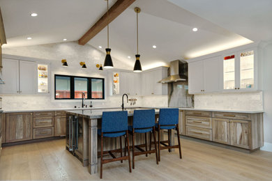 Inspiration for a large transitional u-shaped vinyl floor, multicolored floor and exposed beam open concept kitchen remodel in San Francisco with an undermount sink, shaker cabinets, distressed cabinets, quartzite countertops, white backsplash, marble backsplash, stainless steel appliances, an island and blue countertops