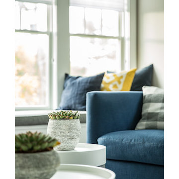 Primary-colored pillows accent the reading nook and living room