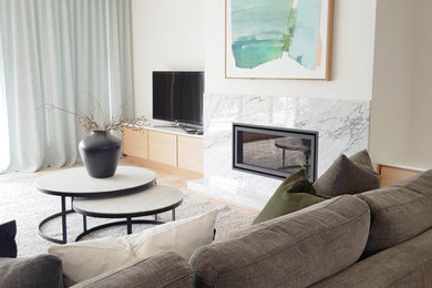 This is an example of a modern living room in Perth with white walls, terra-cotta floors, a standard fireplace and a stone fireplace surround.