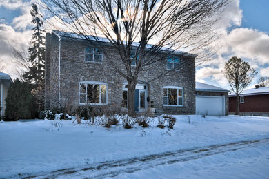 Mid-sized traditional multicolored two-story stone gable roof idea in Ottawa