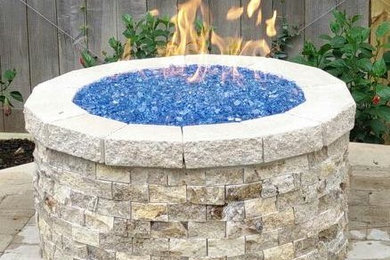 Patio - backyard concrete paver patio idea in Houston with a fire pit