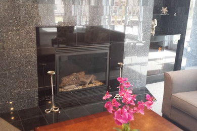Living room - modern dark wood floor living room idea in Other with a standard fireplace and a tile fireplace