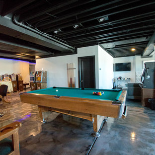 Photo of a large modern walk-out basement in Denver with grey walls, concrete flooring, a ribbon fireplace and a stone fireplace surround.