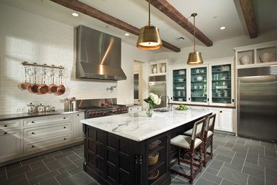 Traditional eat-in kitchen in Houston with beaded inset cabinets and with island.