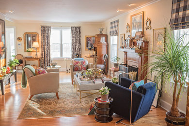Inspiration for a large eclectic formal and enclosed medium tone wood floor and brown floor living room remodel in Bridgeport with beige walls, a standard fireplace, a wood fireplace surround and no tv