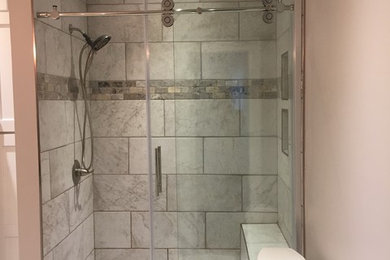 Bathroom - large contemporary master white tile and ceramic tile ceramic tile and white floor bathroom idea in Other with shaker cabinets, white cabinets, a two-piece toilet, beige walls, an undermount sink, marble countertops and black countertops