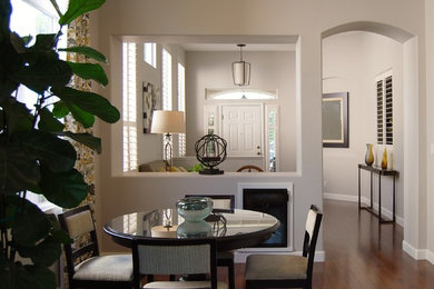 Example of a small trendy open concept dark wood floor and brown floor living room design in San Francisco with gray walls, no fireplace and no tv