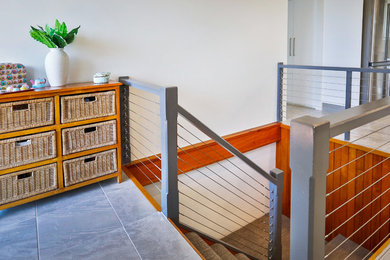 This is an example of a modern carpeted u-shaped staircase in Townsville with carpet risers.