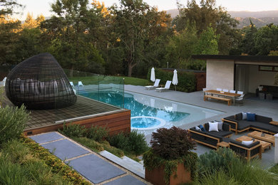 Trendy backyard concrete paver and custom-shaped lap hot tub photo in San Francisco