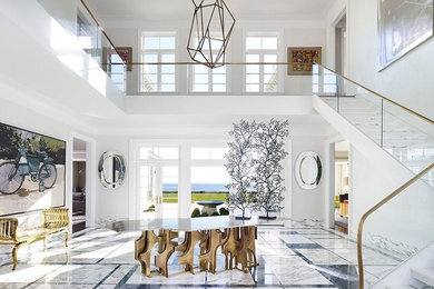 Photo of a large contemporary foyer in New York with white walls, marble floors and multi-coloured floor.