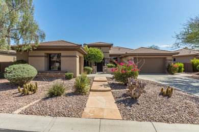 Example of a large southwest beige one-story stucco exterior home design in Phoenix with a shingle roof