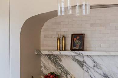 Example of a large classic eat-in kitchen design in Seattle with shaker cabinets, beige cabinets, marble countertops, marble backsplash, an island and white countertops