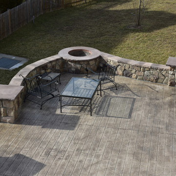 Stone walls, build in fire pit, and plank pattern stamped concrete