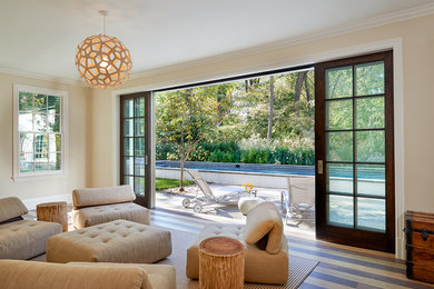 Example of a mid-sized minimalist enclosed light wood floor and multicolored floor family room design in DC Metro with yellow walls, no fireplace and no tv