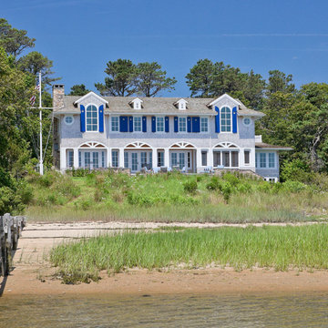 Shingle Style Waterfront Home with Covered Porch & Blue Shutters - Custom home o