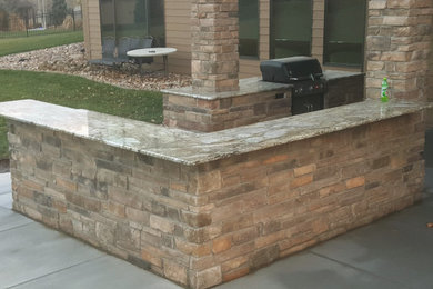 Backyard patio kitchen photo in Omaha