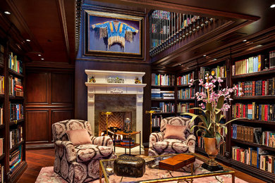 Inspiration for a timeless medium tone wood floor living room library remodel in Phoenix with a standard fireplace and a stone fireplace