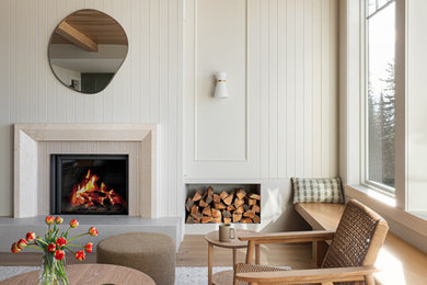 Example of a mid-sized trendy open concept light wood floor, gray floor, wood ceiling and wall paneling living room design in Vancouver with beige walls, a wood stove and a stone fireplace