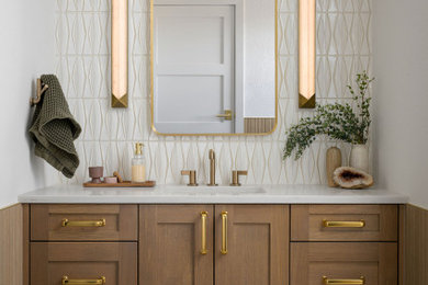 Inspiration for a large transitional master white tile and ceramic tile porcelain tile, beige floor and single-sink bathroom remodel in Denver with shaker cabinets, medium tone wood cabinets, a one-piece toilet, white walls, an undermount sink, quartz countertops, white countertops and a built-in vanity