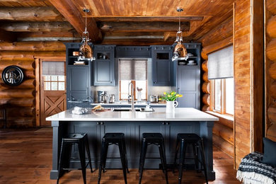 Example of a mid-sized mountain style galley medium tone wood floor and brown floor kitchen design in Toronto with an undermount sink, beaded inset cabinets, gray cabinets, white backsplash, paneled appliances and an island